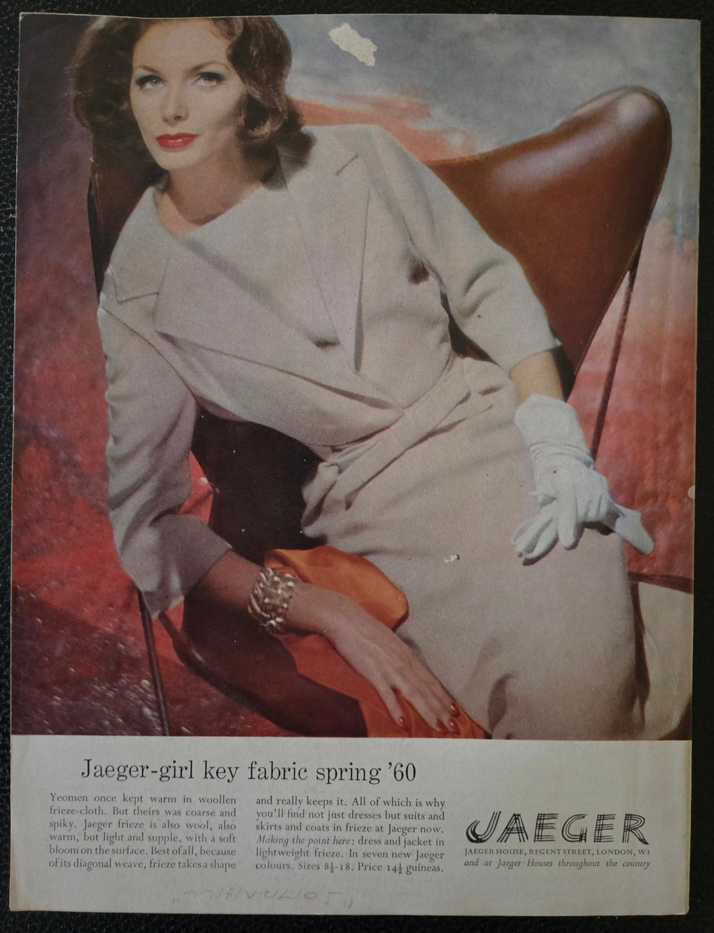 Vintage advertisement featuring a woman in a beige coat and gloves sitting on a red couch, with 'Jaeger' branding.