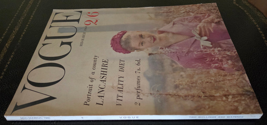 Vintage Vogue magazine cover with a woman in a pink dress and hat.