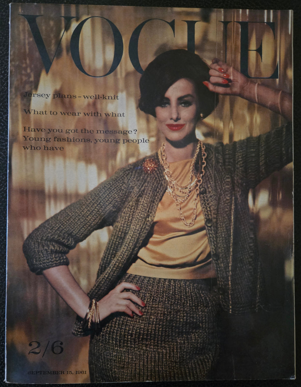 Vogue magazine cover with a model in a textured outfit on a dark background