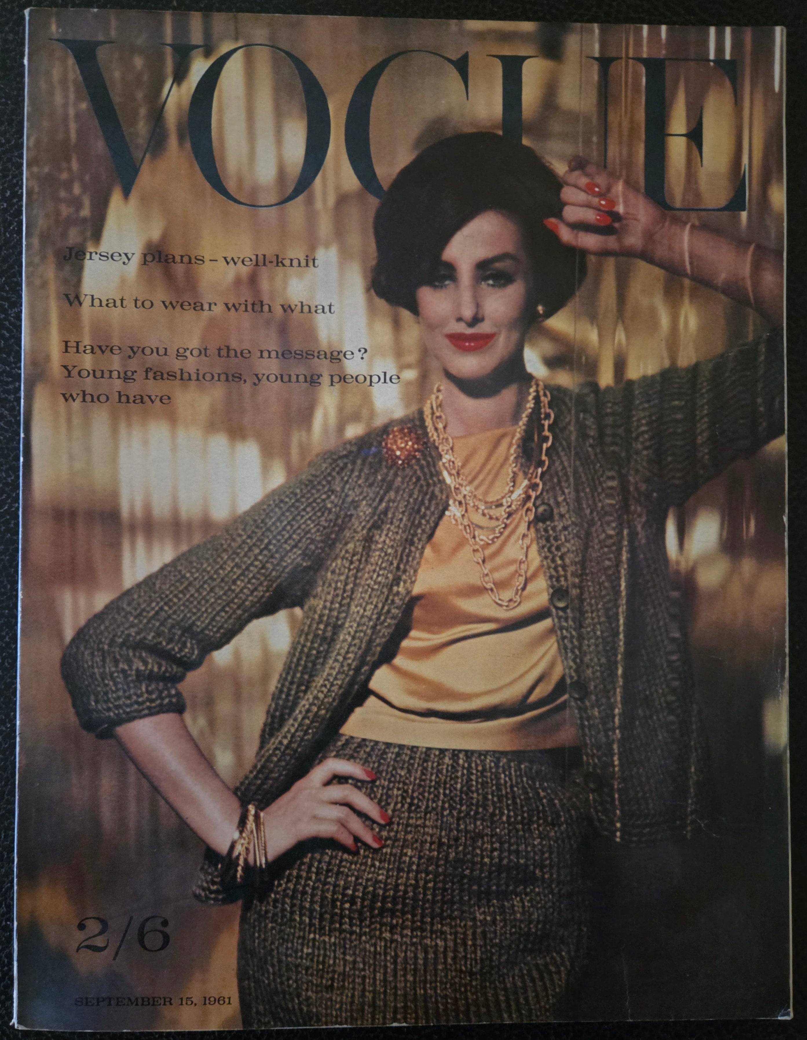 Vogue magazine cover with a model in a textured outfit on a dark background