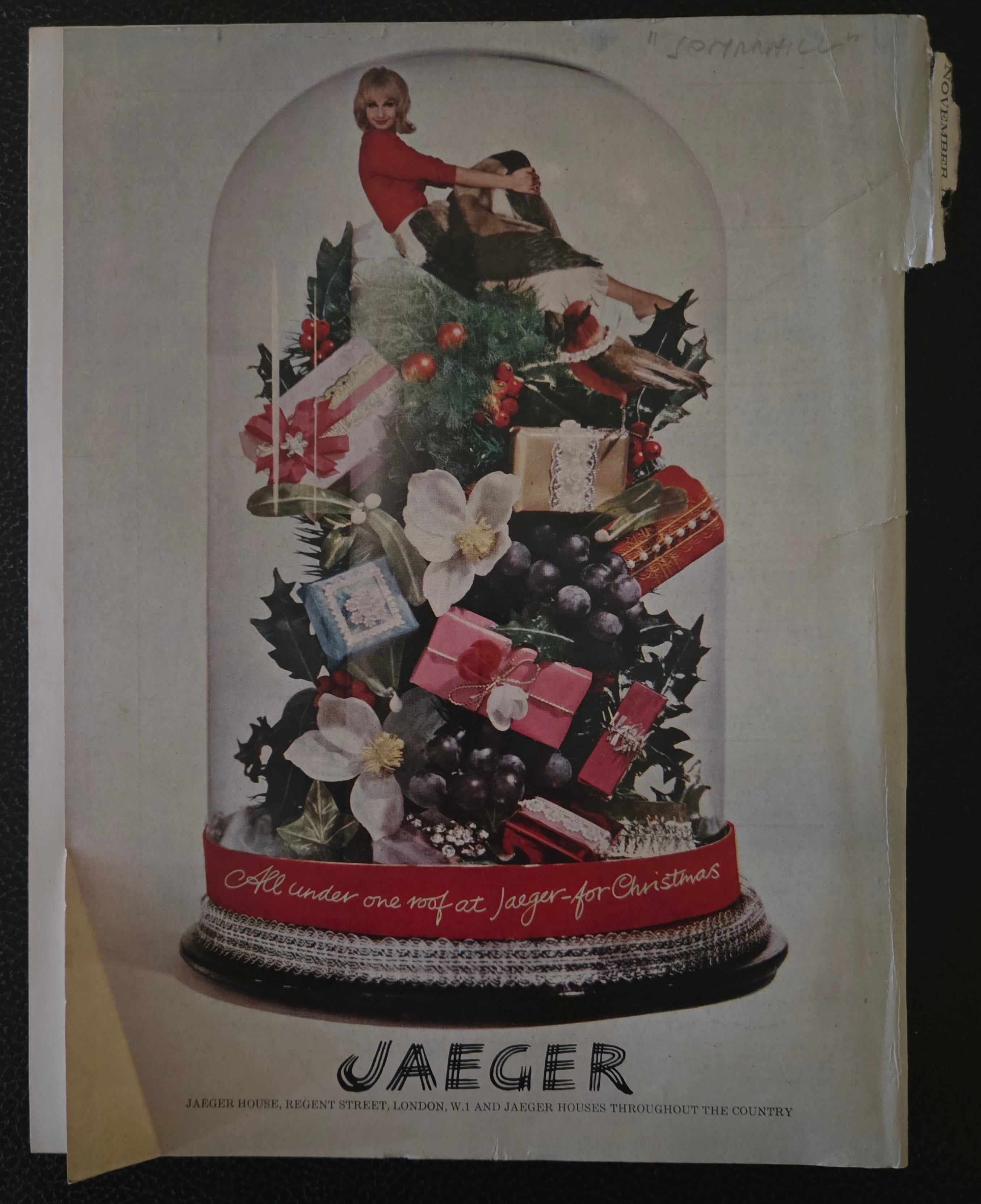 Vintage Jaeger Christmas advertisement with a snow globe design .