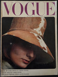 Vintage Vogue magazine cover with a woman wearing a large hat.
