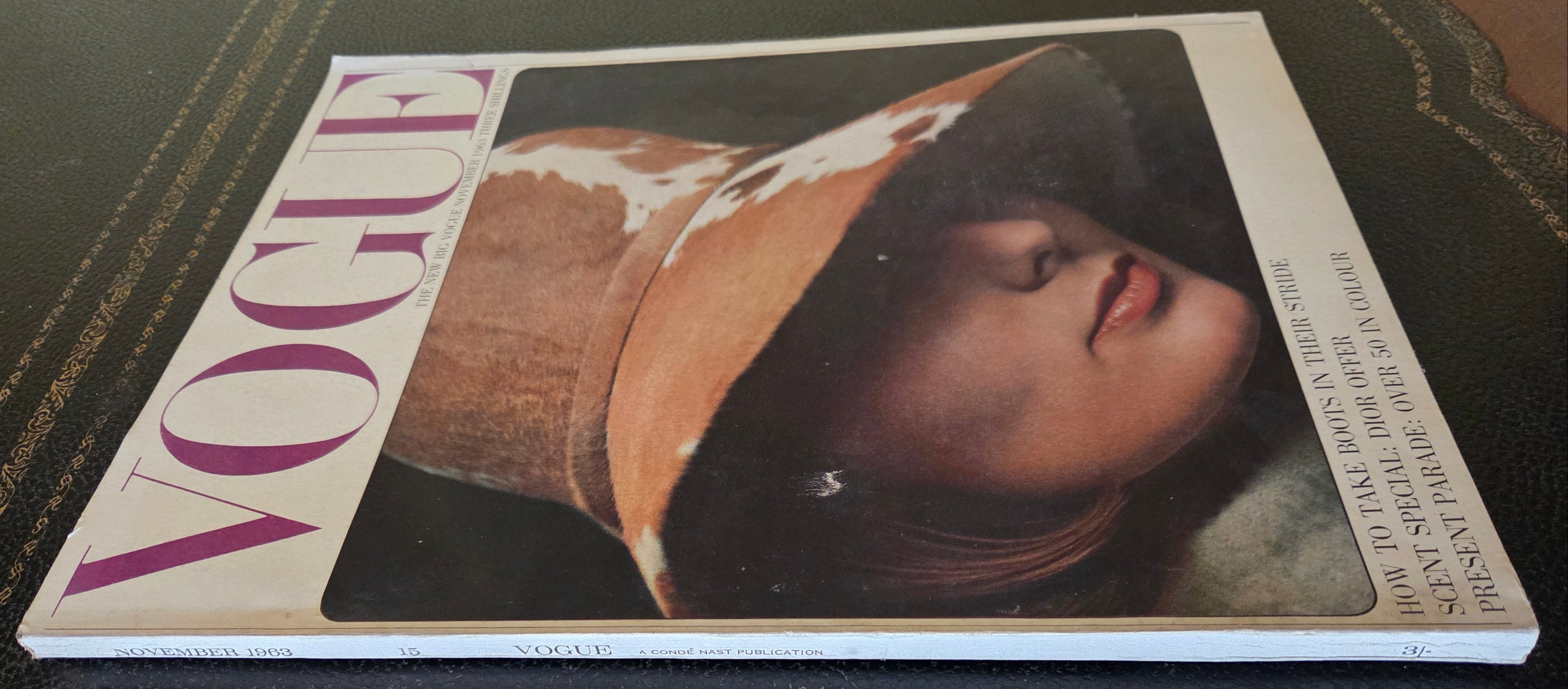 Vintage Vogue magazine with a cover featuring a woman wearing a hat