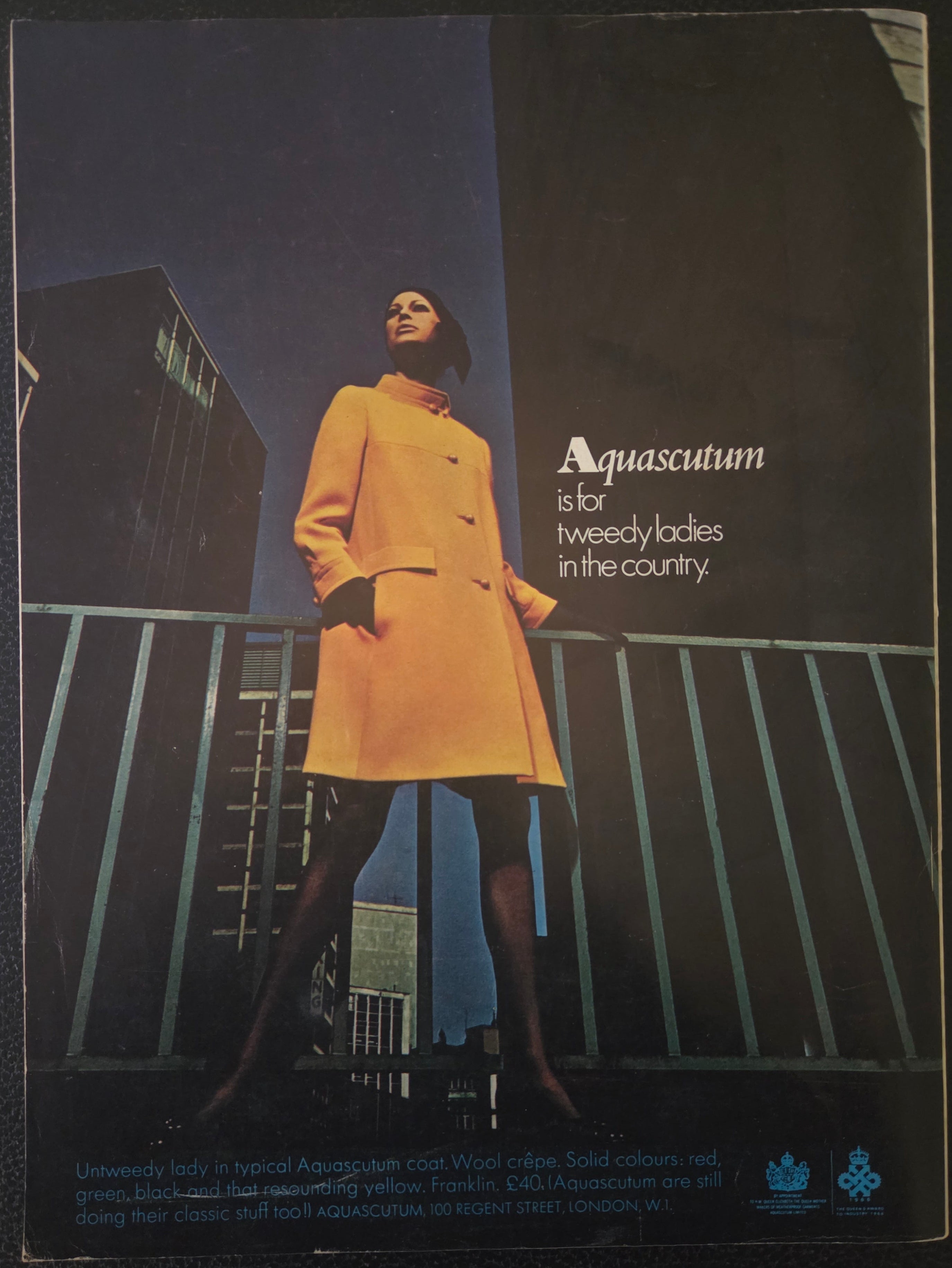 Vintage advert for Aquascutum with model in yellow coat.