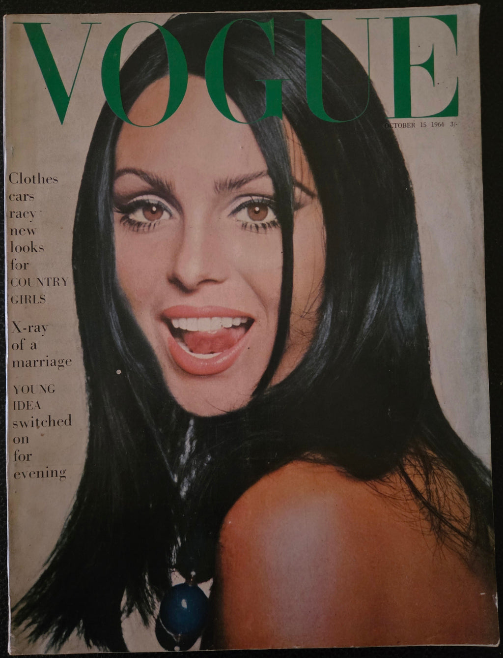 Vintage Vogue magazine cover with a woman's face and the word 'Vogue' in green.