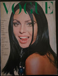 Vintage Vogue magazine cover with a woman's face and the word 'Vogue' in green.