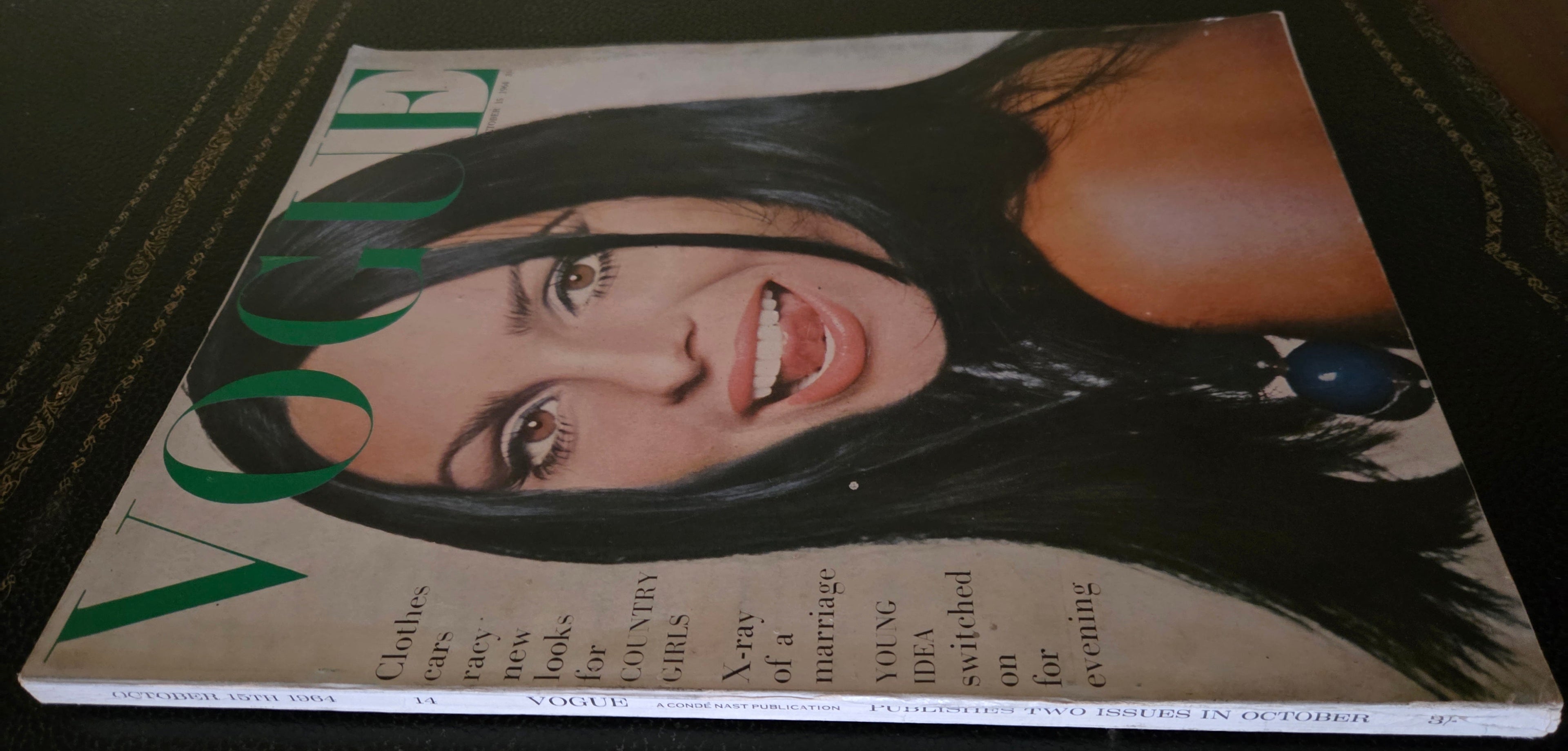 Vogue magazine with a cover featuring a woman's face.