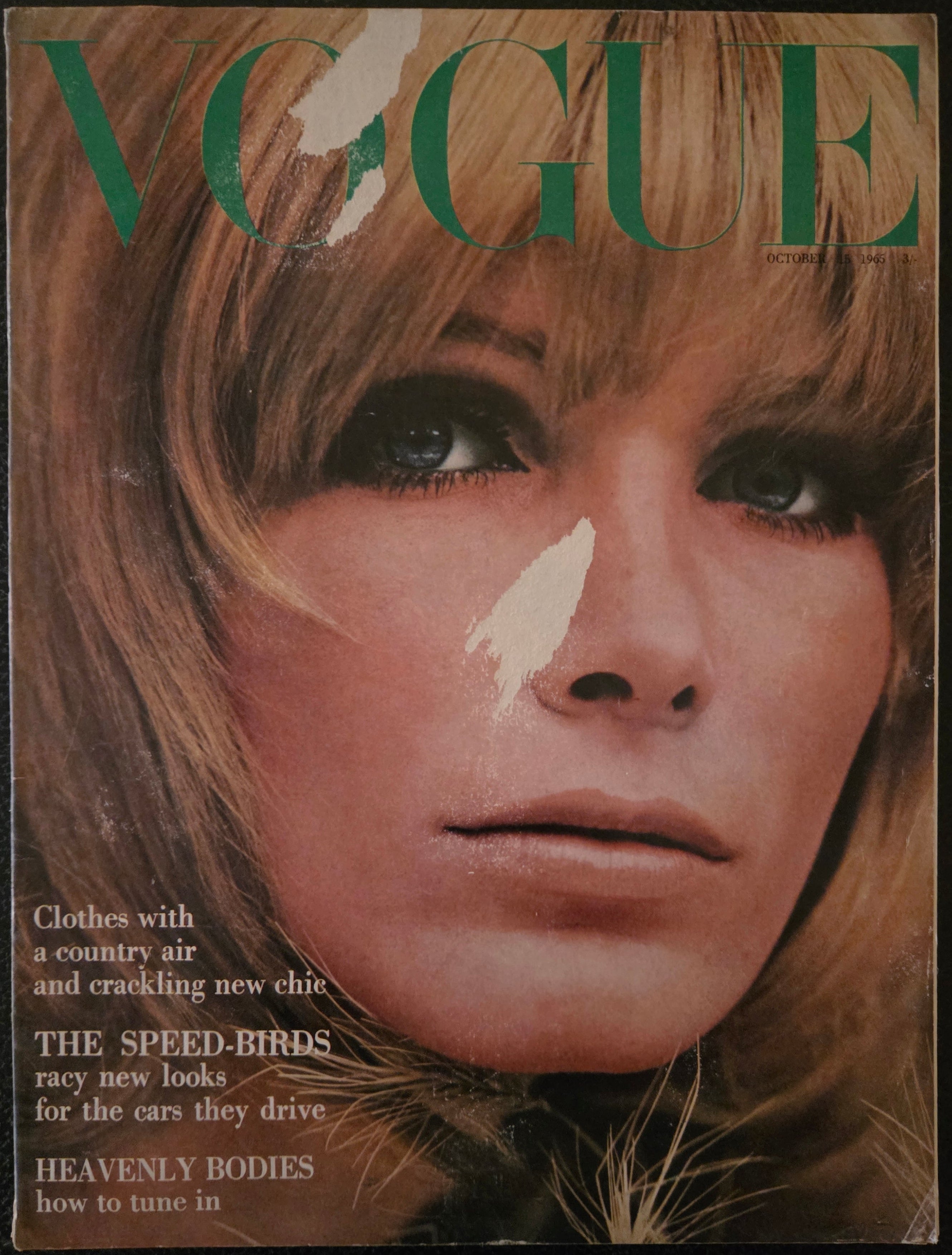 Magazine cover with a close-up of a person's face and visible text.