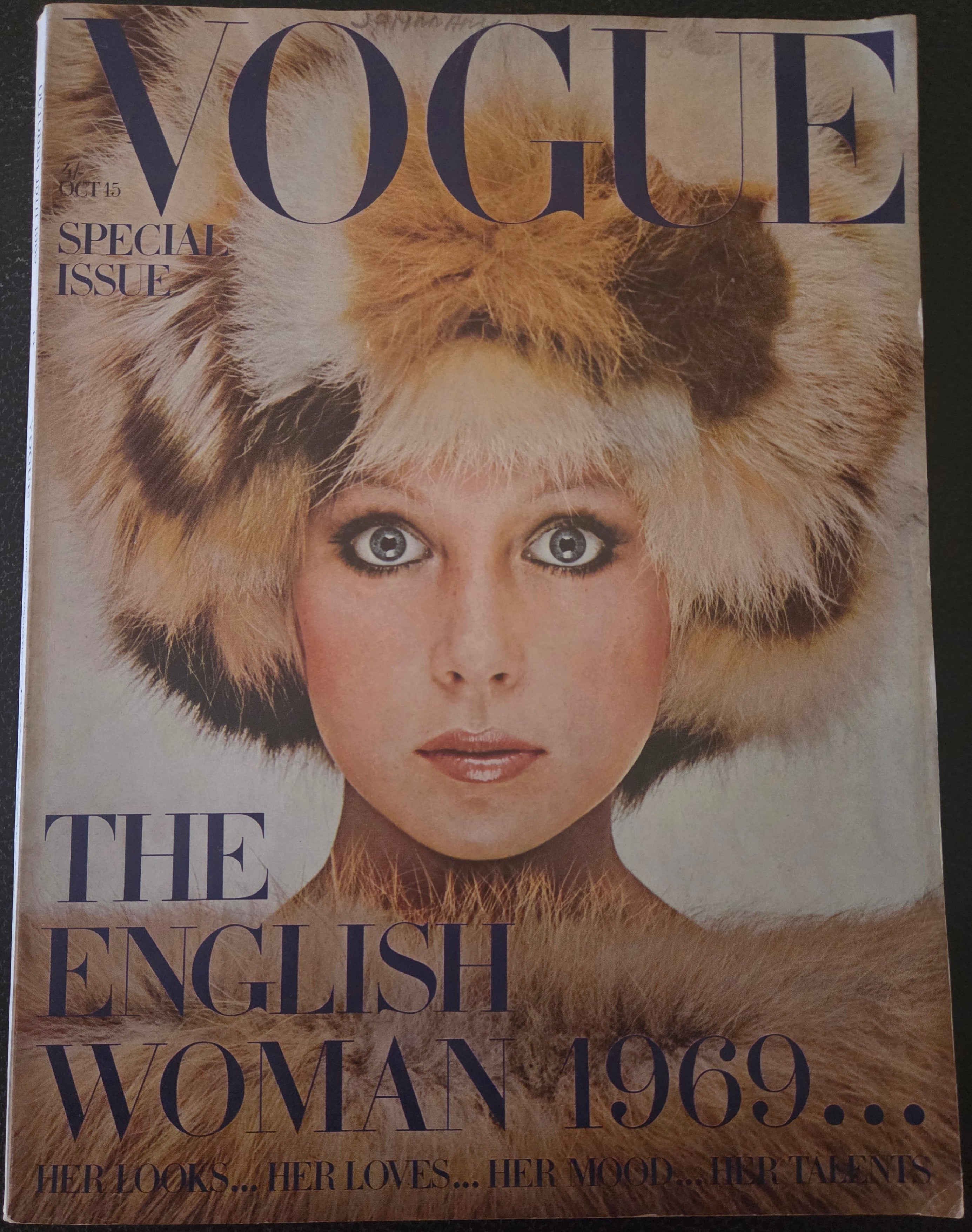 Vogue magazine cover featuring a woman with a fur hat.