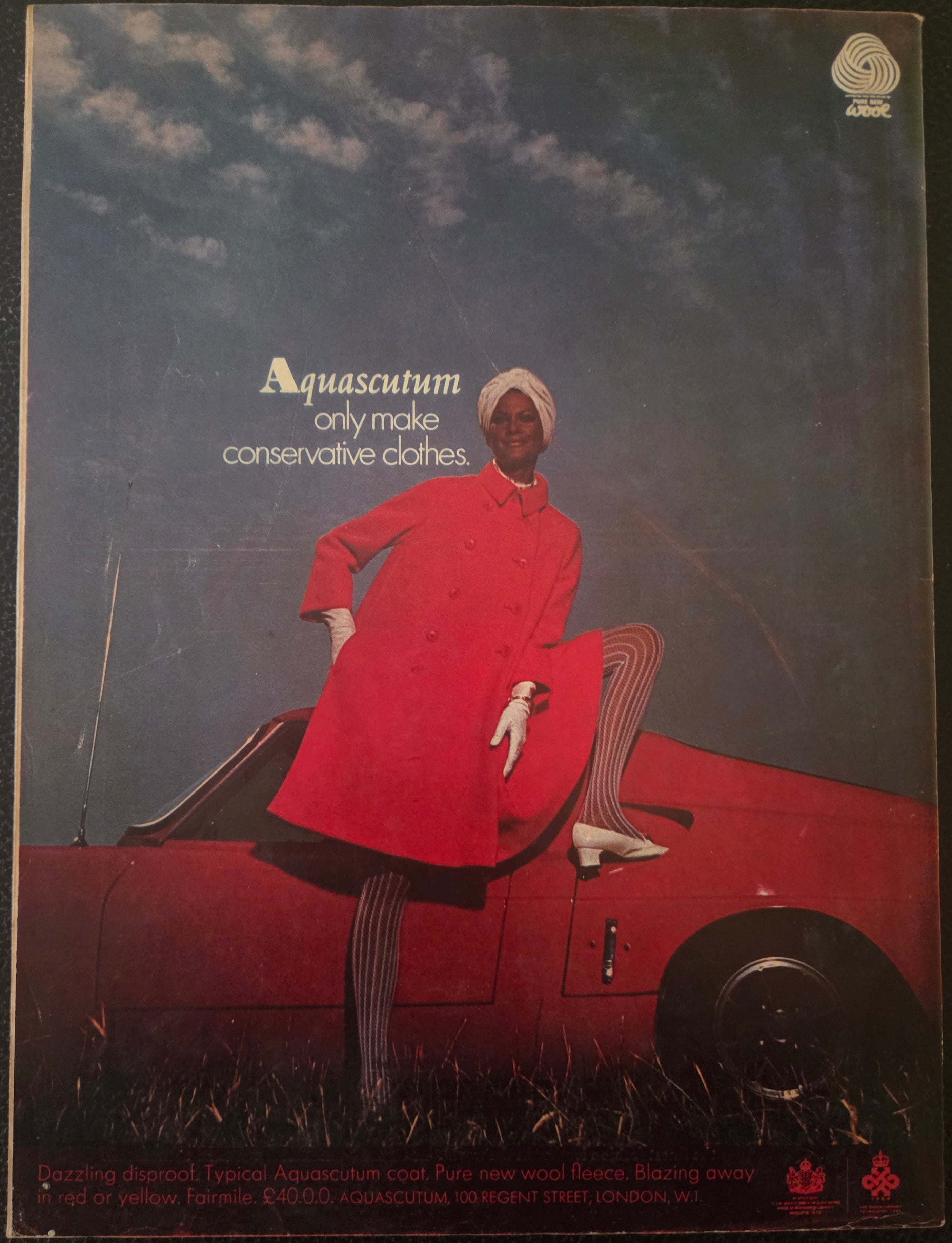 Vintage advert for Aquascutum with woman in red coat sitting on red car.