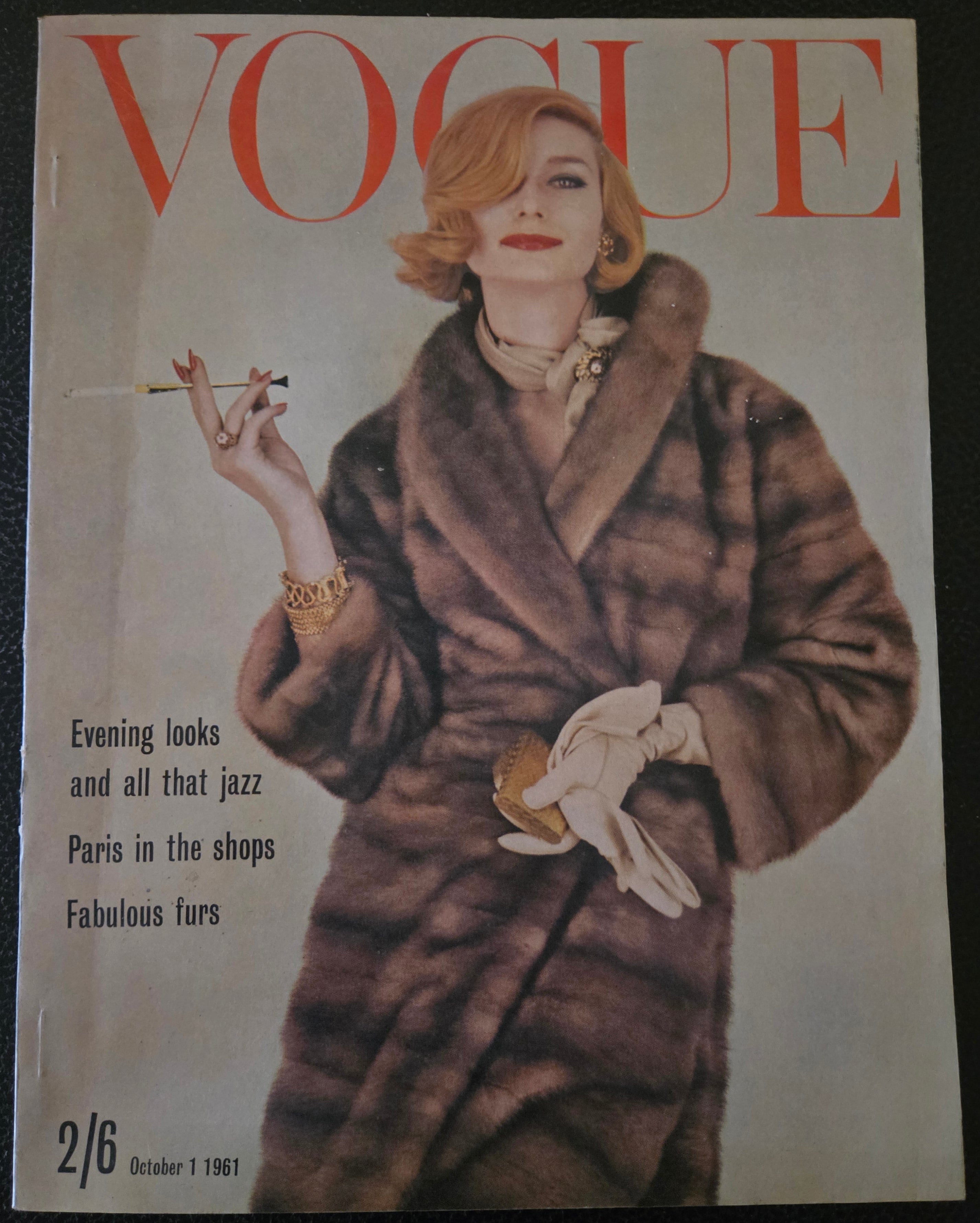 Vintage vogue featuring model in fur coat holding a cigarette