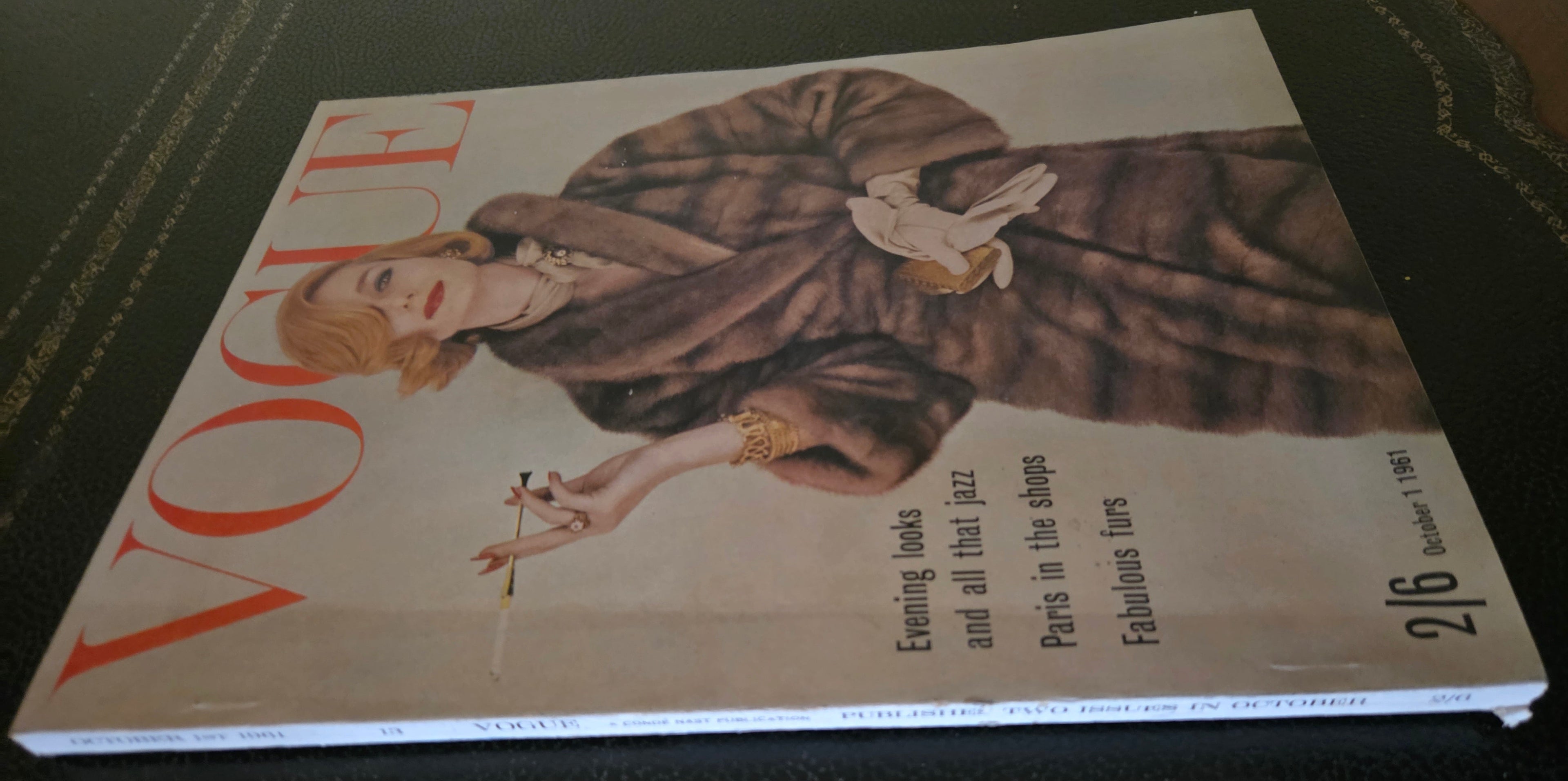 Vintage Vogue magazine cover with a model in a fur coat.