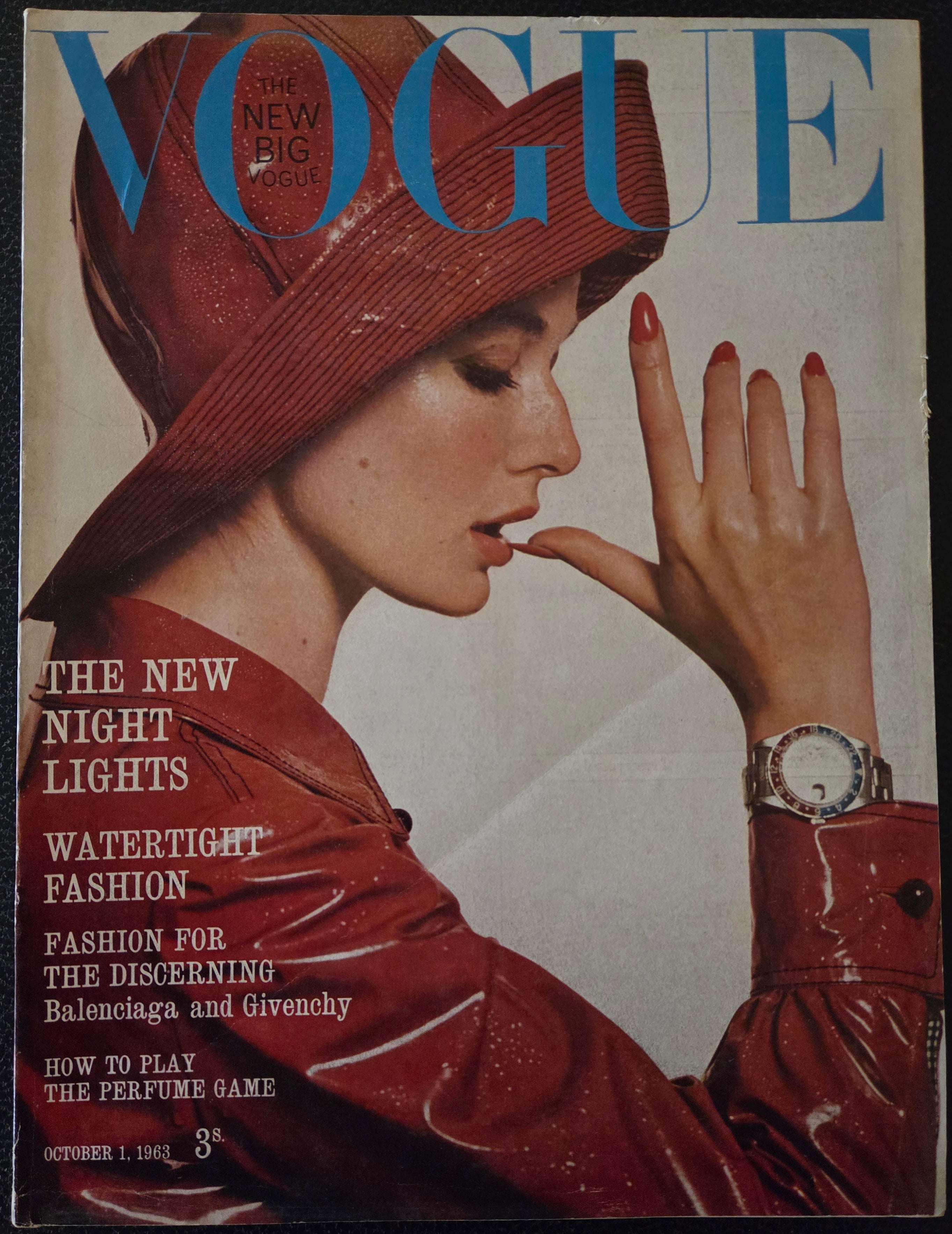 Vintage vogue with a model in a red raincoat and hat.