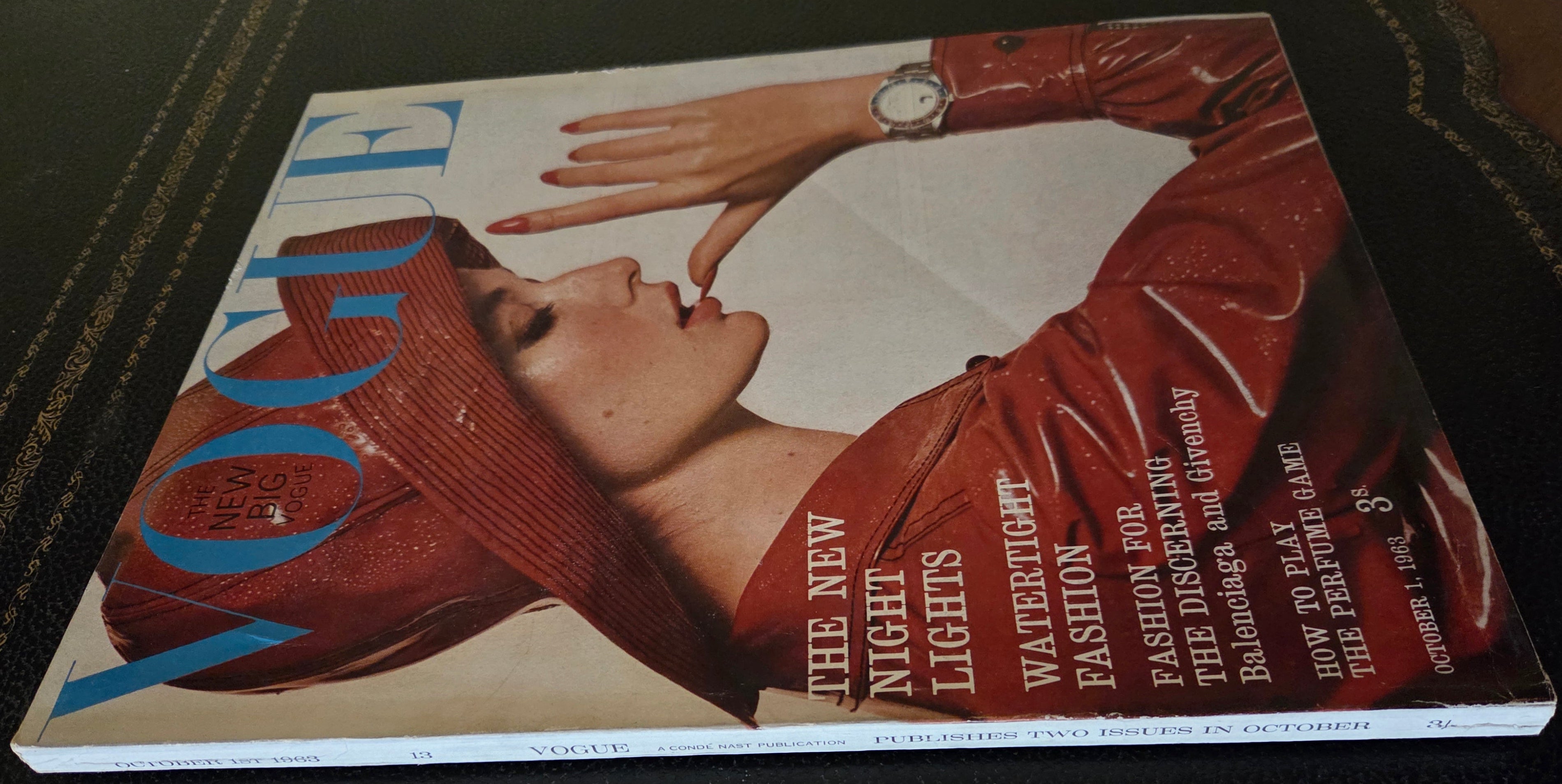 Vintage vogue with a model in a red raincoat and hat.