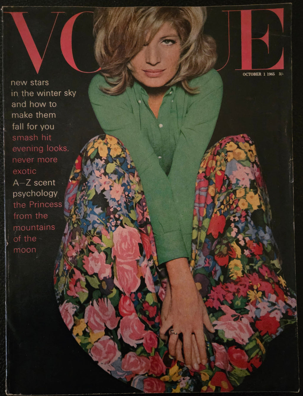 Vintage magazine cover with a woman wearing a floral skirt and green shirt.