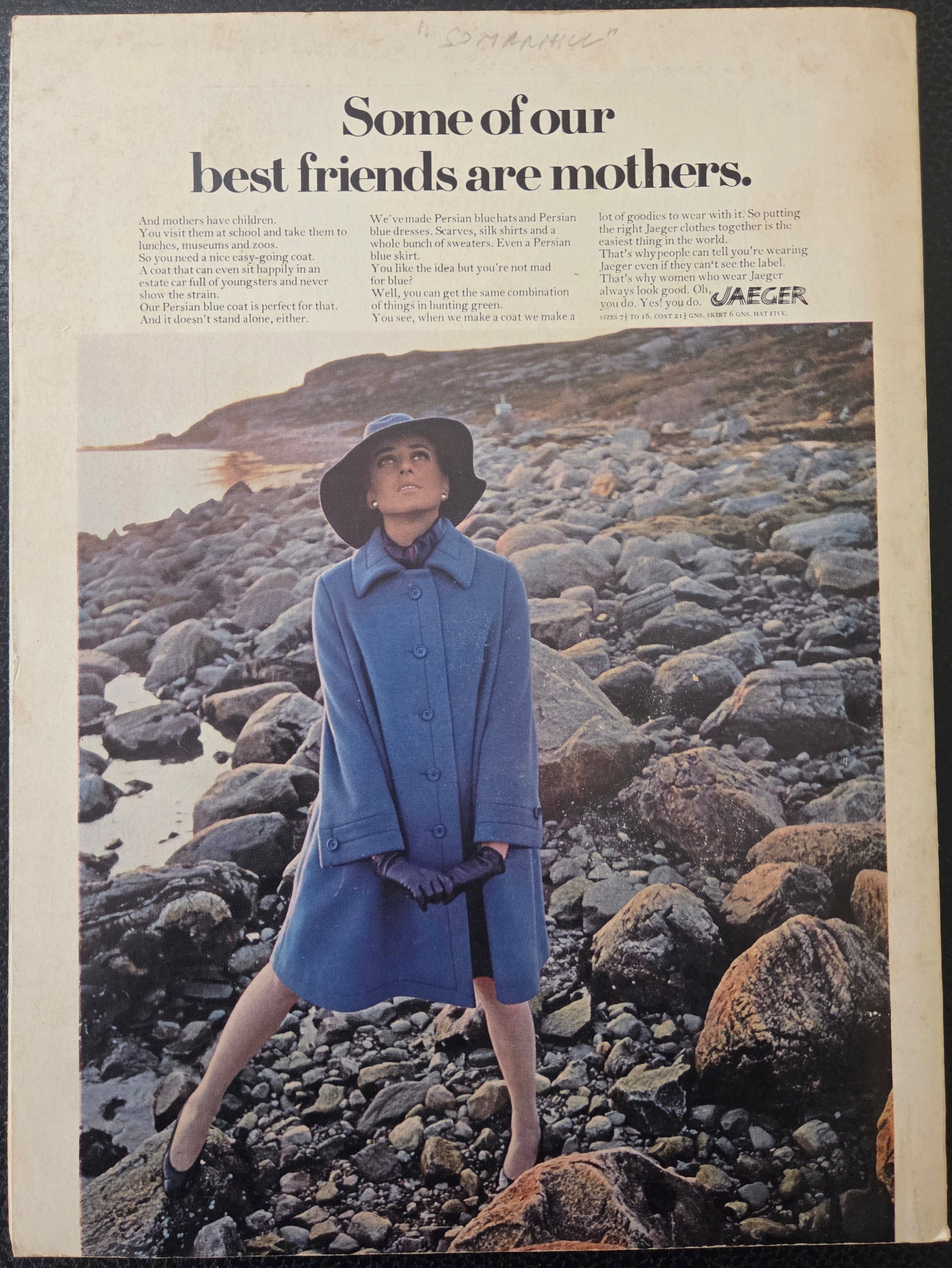 Woman in a blue coat standing on rocky terrain with text about friends being mothers.