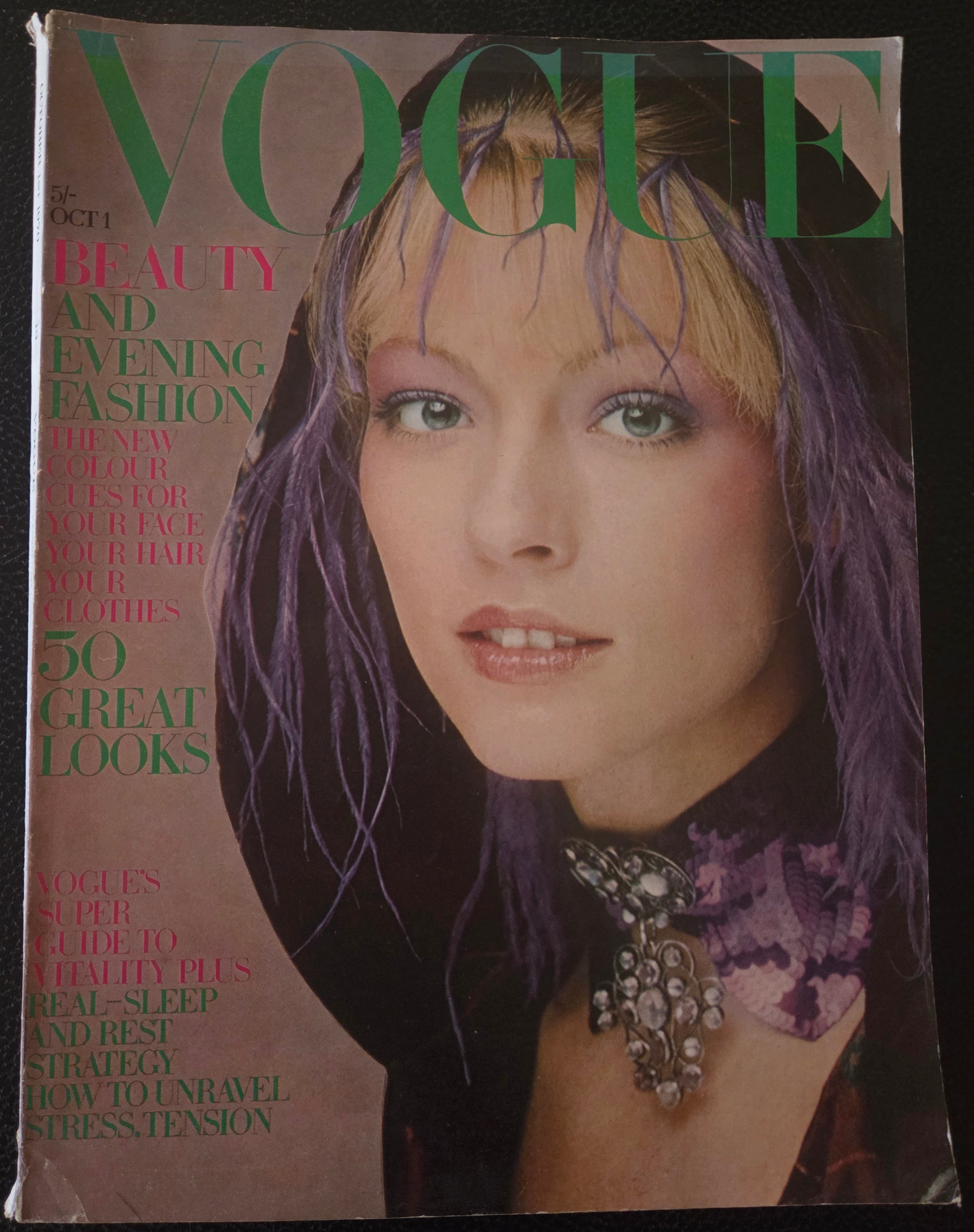 Vintage vogue with model with purple feathers in her hair.