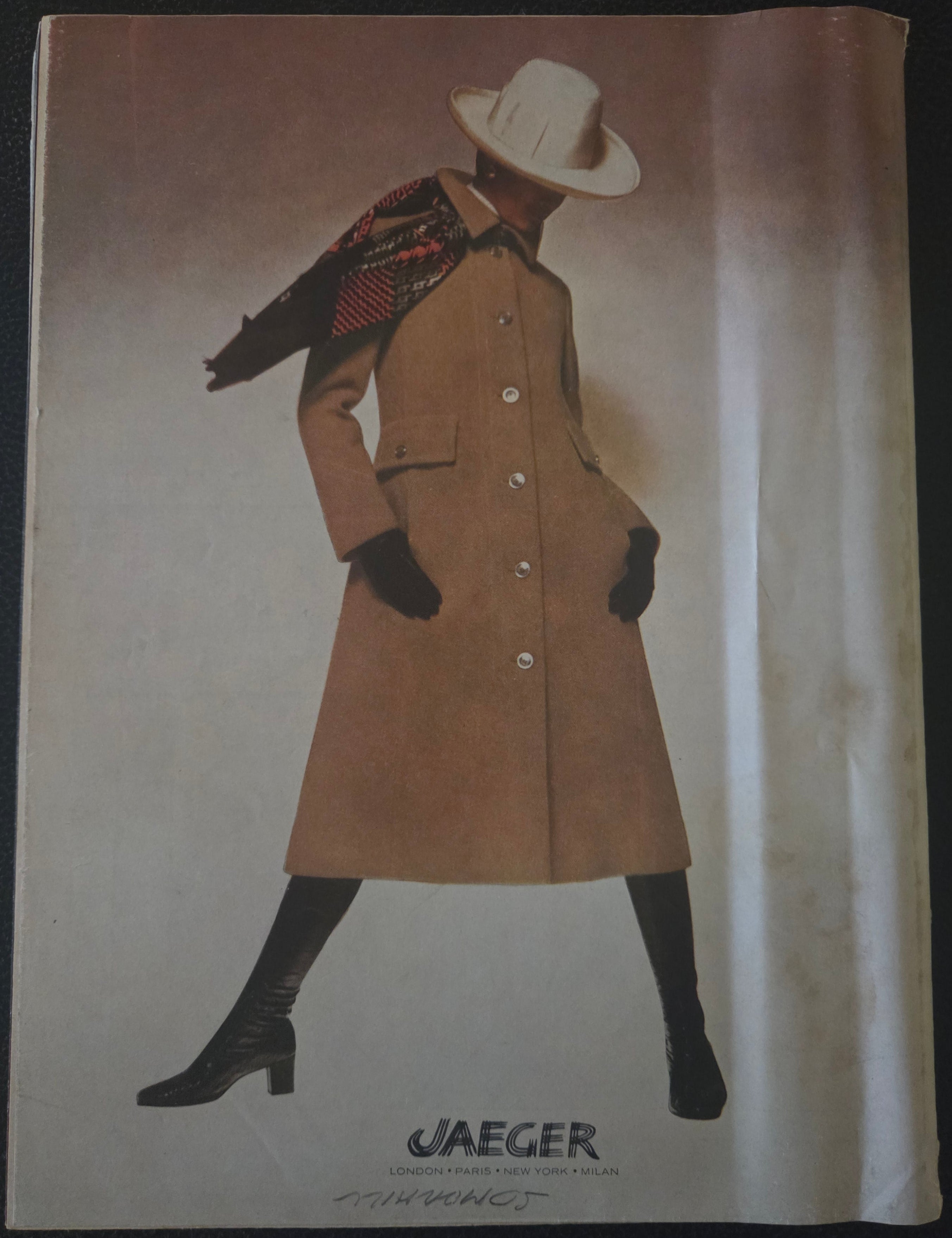 Vintage advertisement for Jaeger clothing with a person wearing a coat and hat.