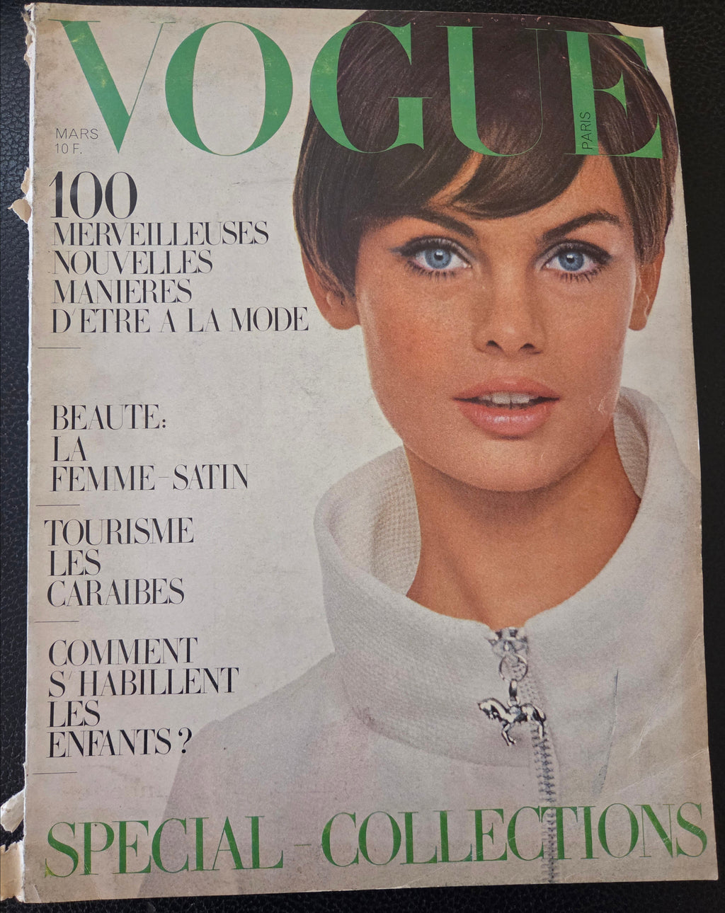 Vintage Vogue magazine cover with a woman's face and text
