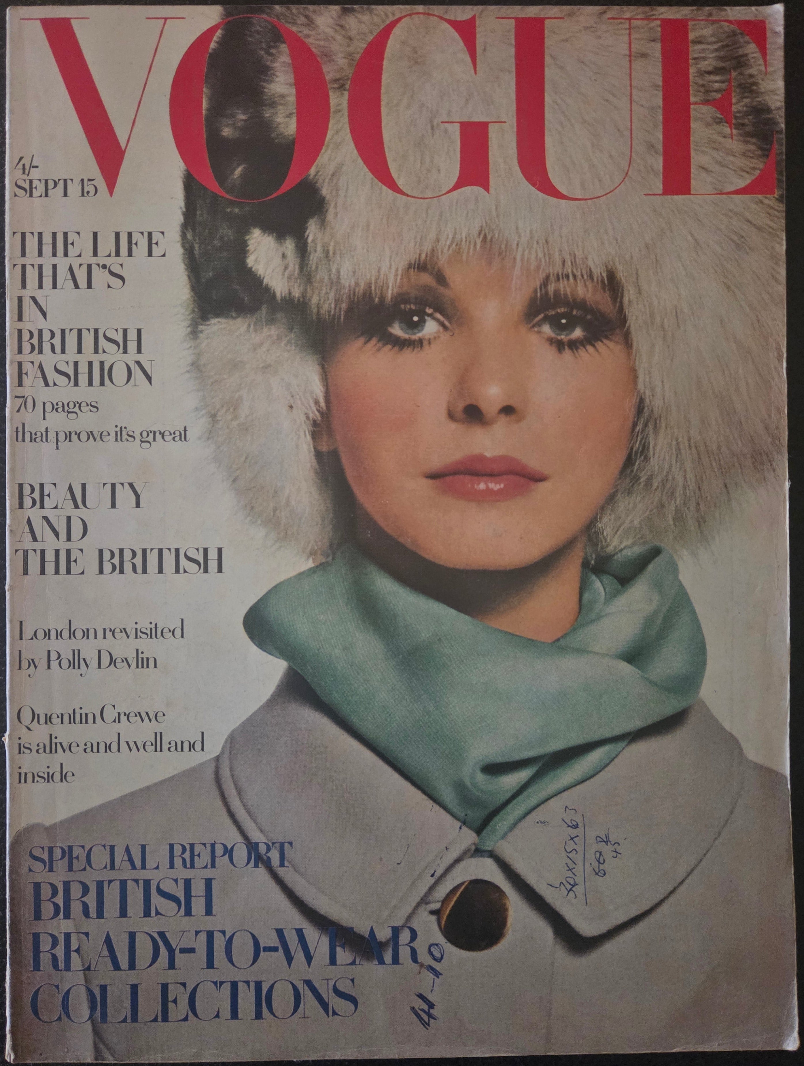 Vintage Vogue magazine cover with a model wearing a fur hat and coat.