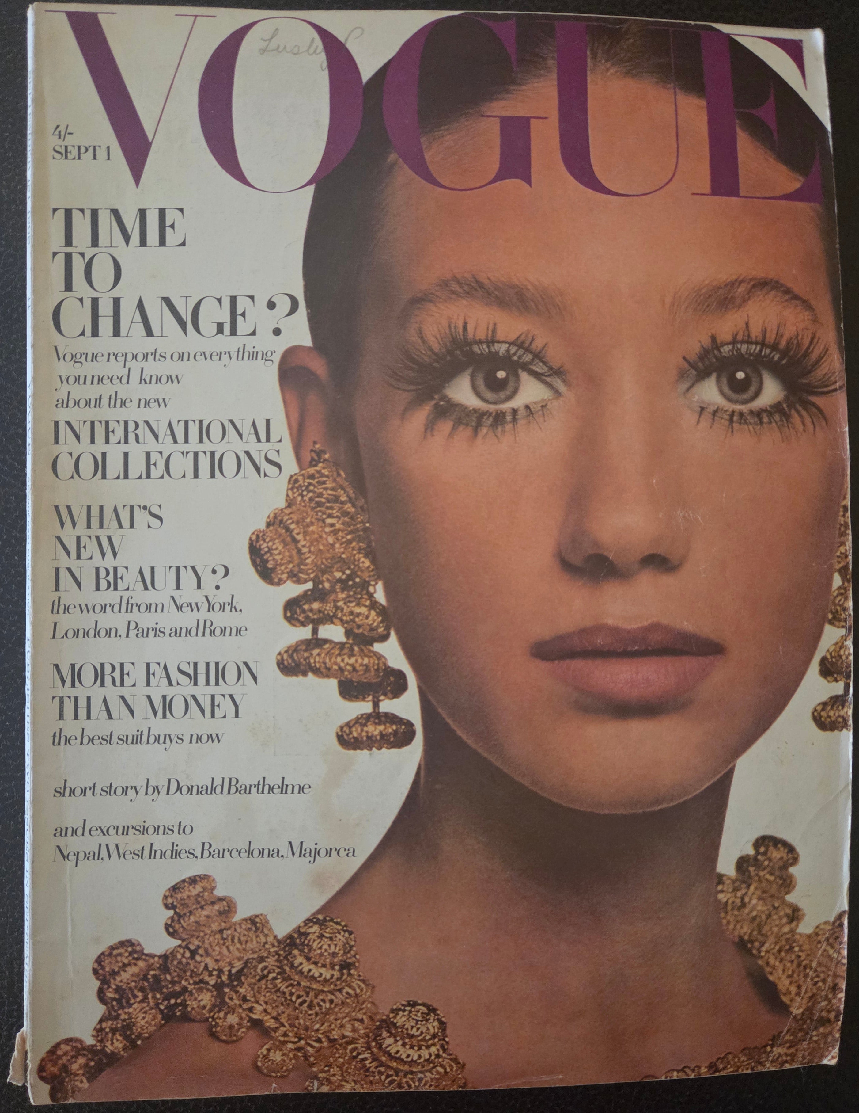 Vogue magazine cover with a close-up of a woman's face and text.