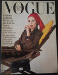 Vogue magazine cover with a model wearing a red headscarf and brown outfit.