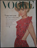 Vintage Vogue magazine cover with a model wearing a red floral dress.