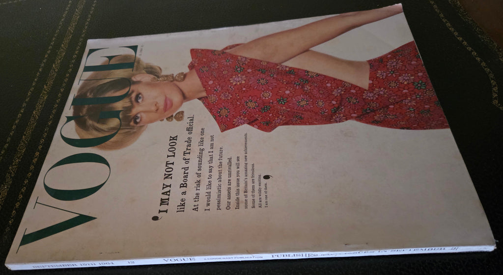 Vintage Vogue magazine cover with a woman in a red dress