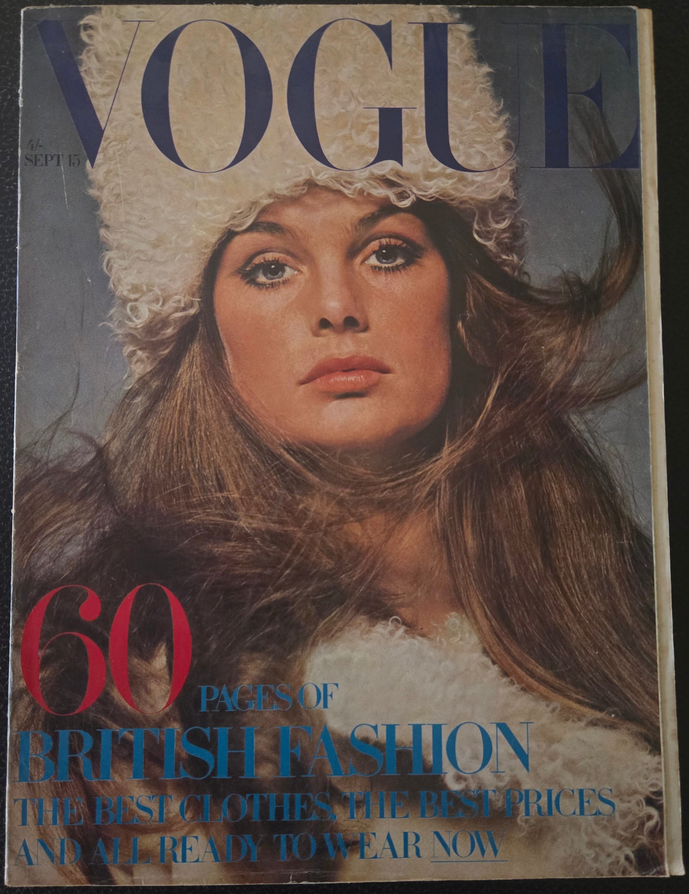 Vintage Vogue magazine cover with a model's face and text on a dark background