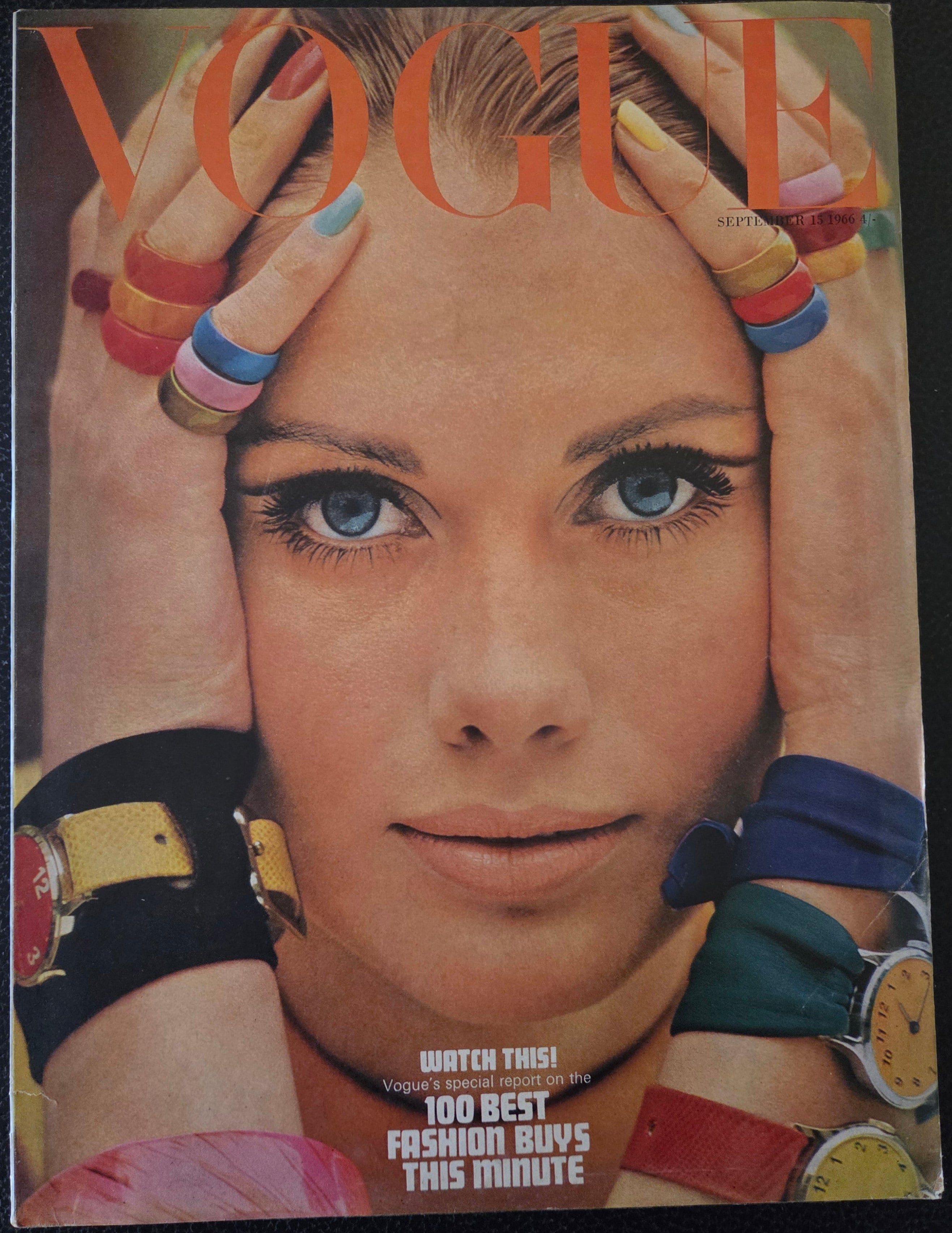 Magazine cover with a close-up of a person's face surrounded by colorful accessories.